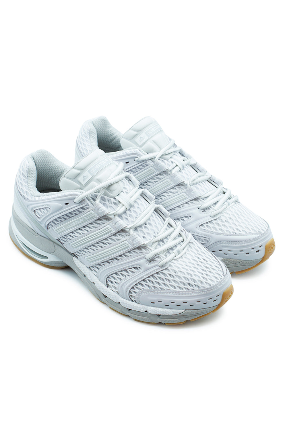Studio shot of a pair of Adidas Adistar Control 5 sneakers placed together at an angle, displaying the retro millennium technical running aesthetic.