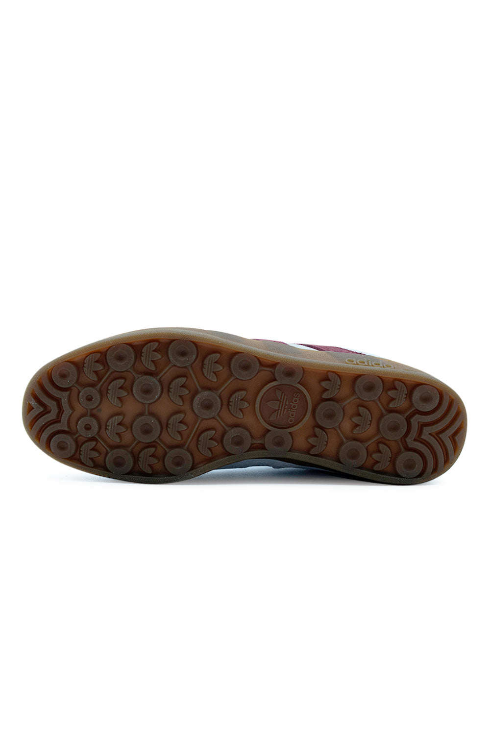 Bottom view of Adidas Aloha Super gum rubber outsole featuring honeycomb grip pattern for skateboarding.