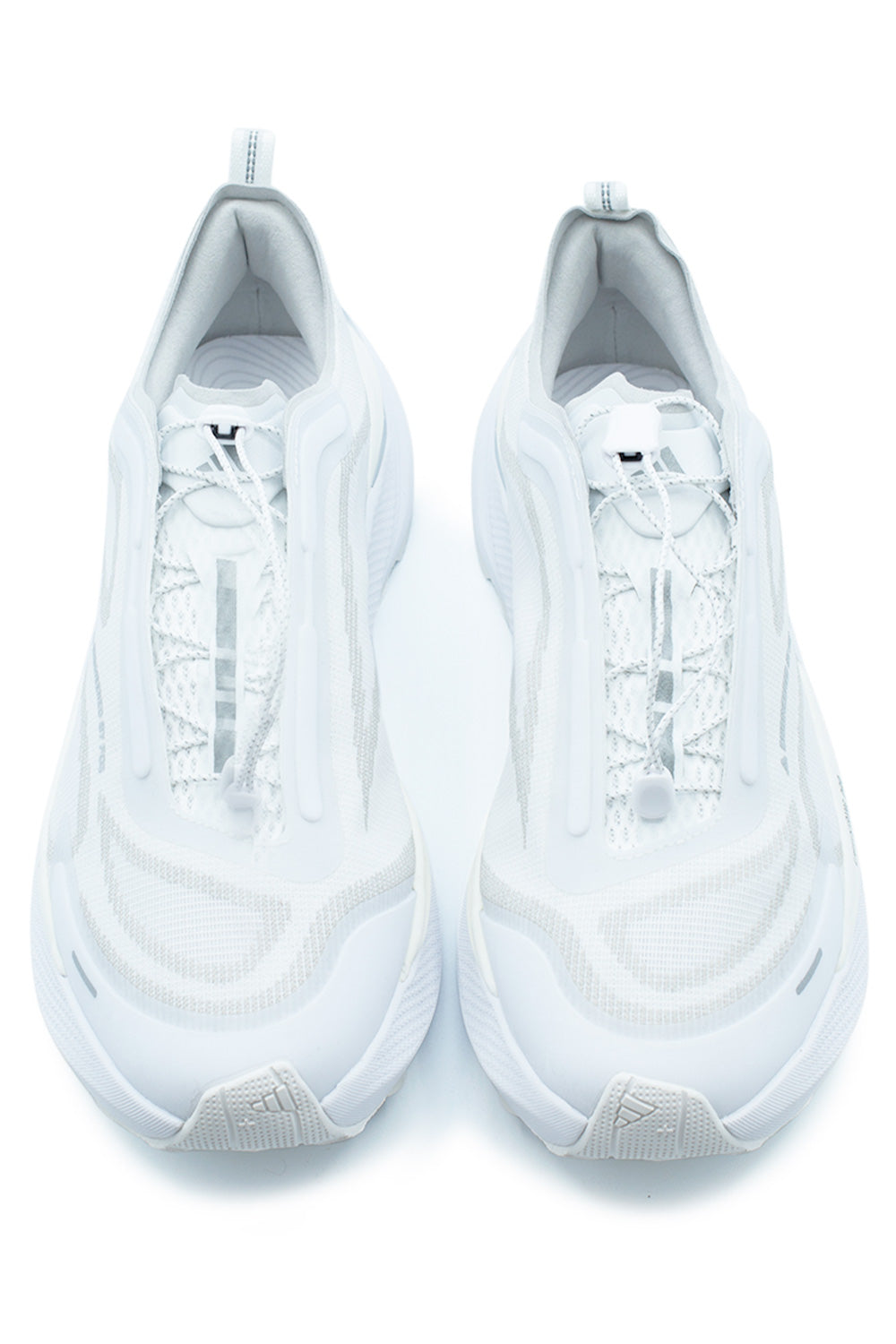 Top-down view of a pair of adidas Holo Peak Cloud White sneakers, highlighting the progressive quick-lacing system with a white toggle and layered wave-like textures.