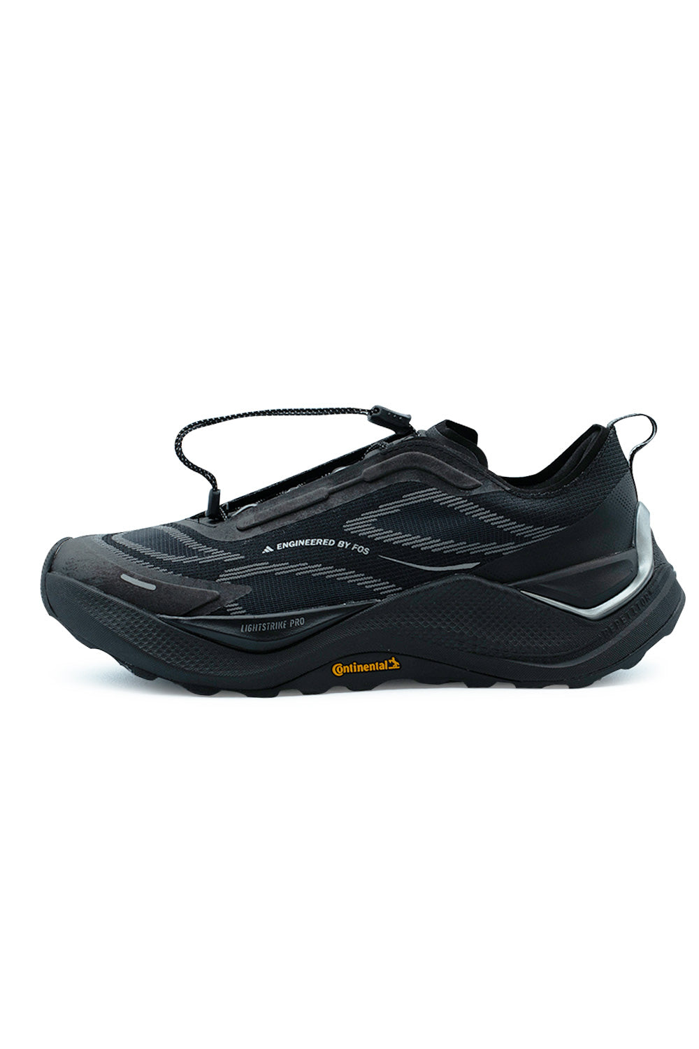 Lateral side profile view of the Adidas Holo Peak trail sneaker in Core Black and Iron Metallic, showcasing the breathable textile upper with Engineered by FOS linear graphics, chunky black Lightstrike Pro foam midsole, metallic silver heel clip counter, and rugged Continental rubber outsole with orange logo branding.