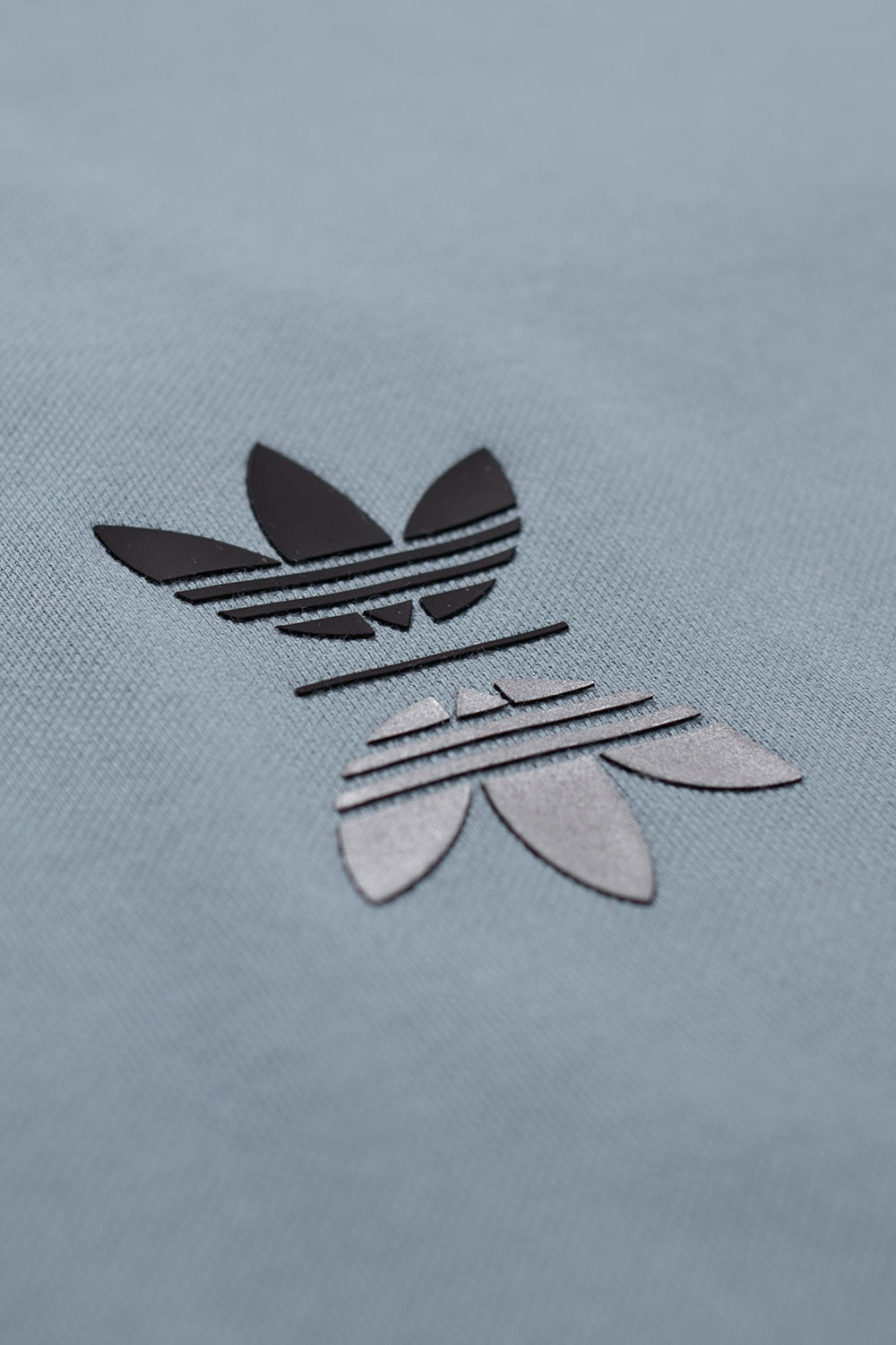 Adidas Trefoil and Metalwood Studio back logo detail on Green Earth polo shirt emphasizing sustainable materials, skate x golf collaboration and 90s-inspired modern golf fashion