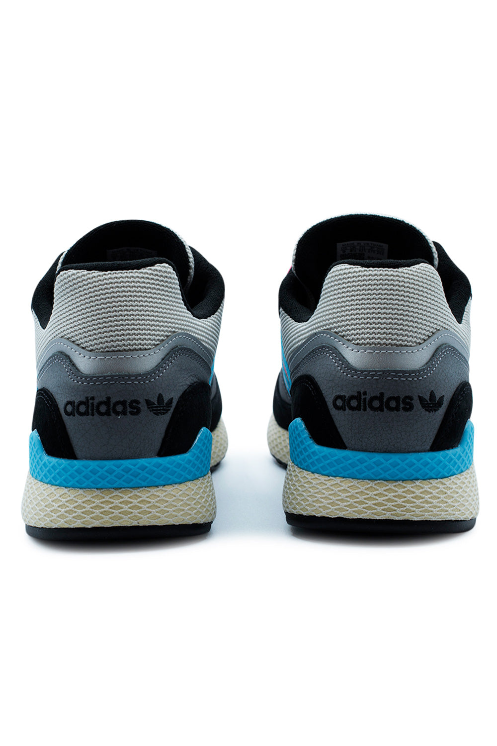 Rear heel view of the Adidas Oregon Ultra Tech shoes showing the black embroidered Adidas Trefoil logo on grey smooth leather, sitting above a blue heel stabilizer and webbed cushioning.