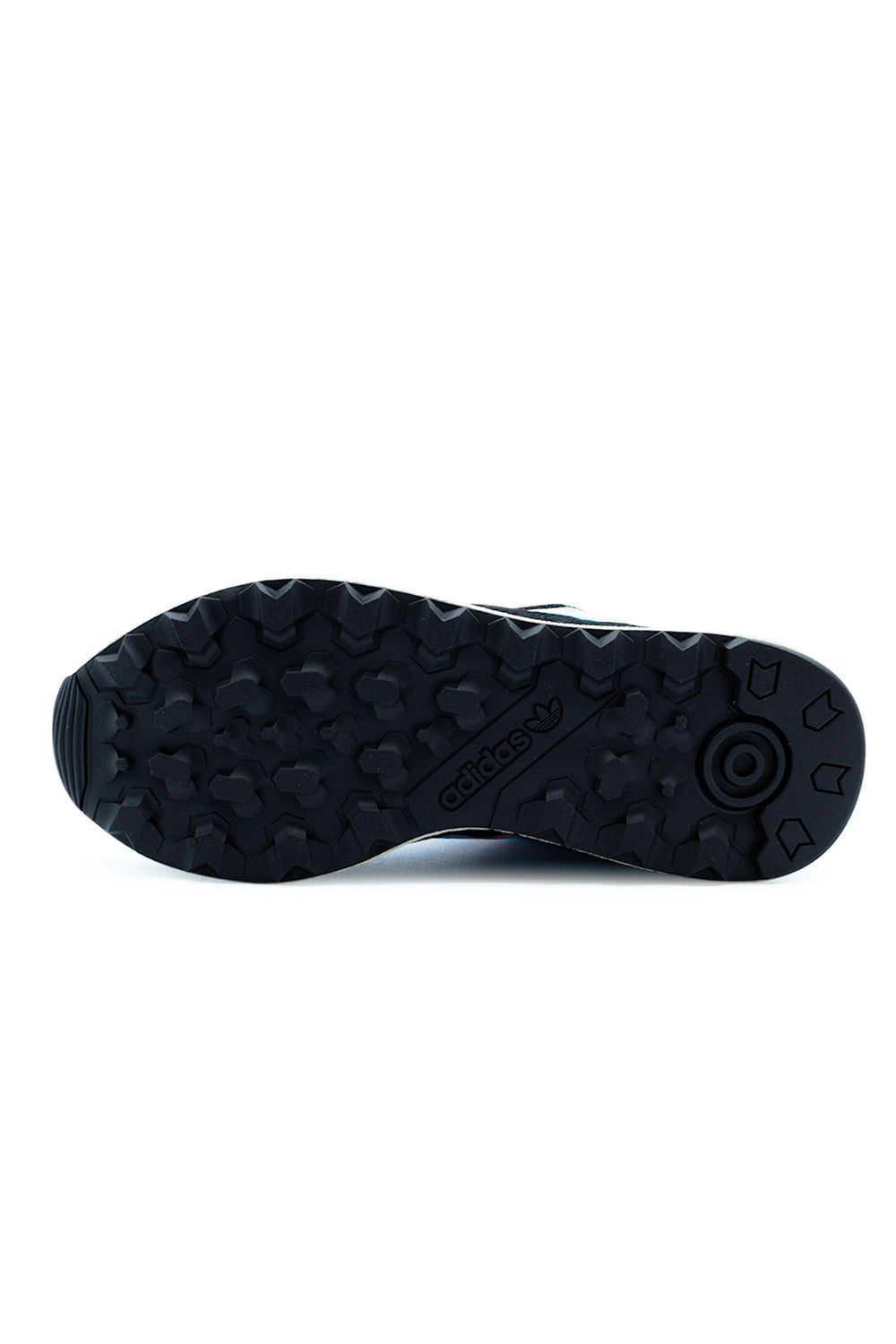 Full view of the black rubber outsole of the Adidas Oregon Ultra Tech, showcasing the heavy-duty tread traction pattern and a centered Adidas Trefoil logo.