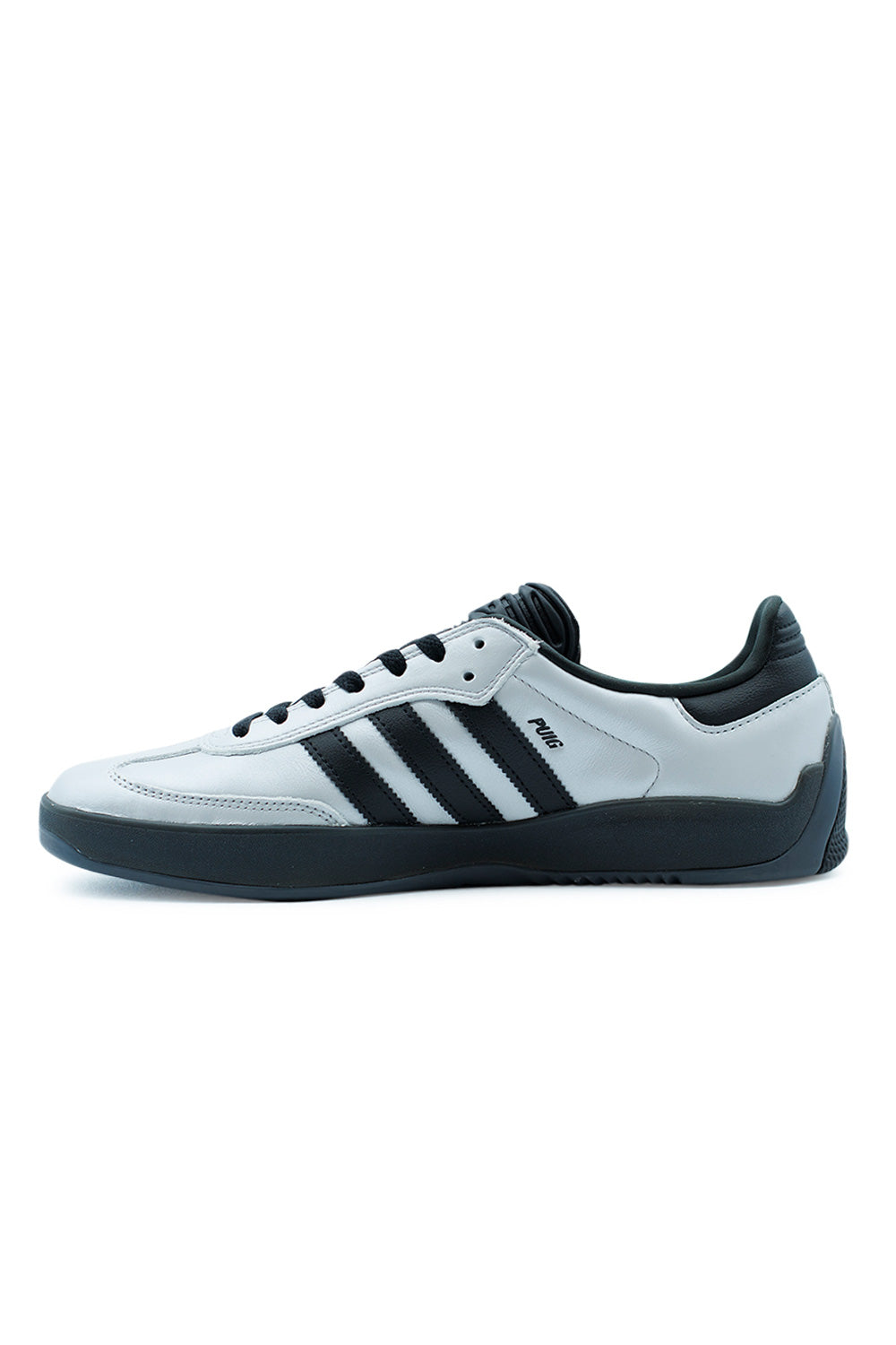 Profile shot of Adidas Puig Samba HQ4747 skate sneakers with metallic silver upper, classic football heritage styling and durable black rubber sole for street and skate use