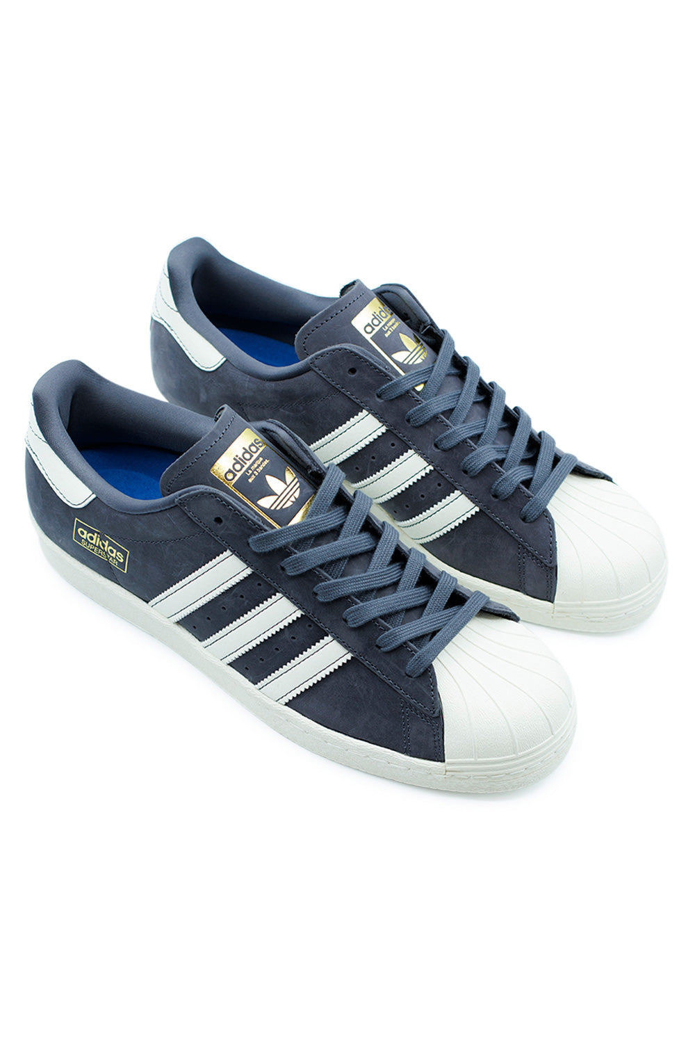 Angled pair view of Adidas Superstar 80 ADV shoes in Aurora Onix colorway with iconic shell toe and skate-ready construction