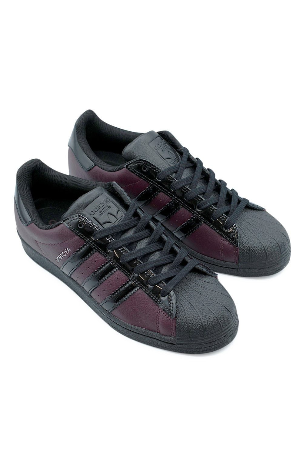 Adidas Superstar ADV Marcos Montoya signature sneakers maroon black angled pair shot, full grain leather upper with stitched cupsole built for skateboarding performance