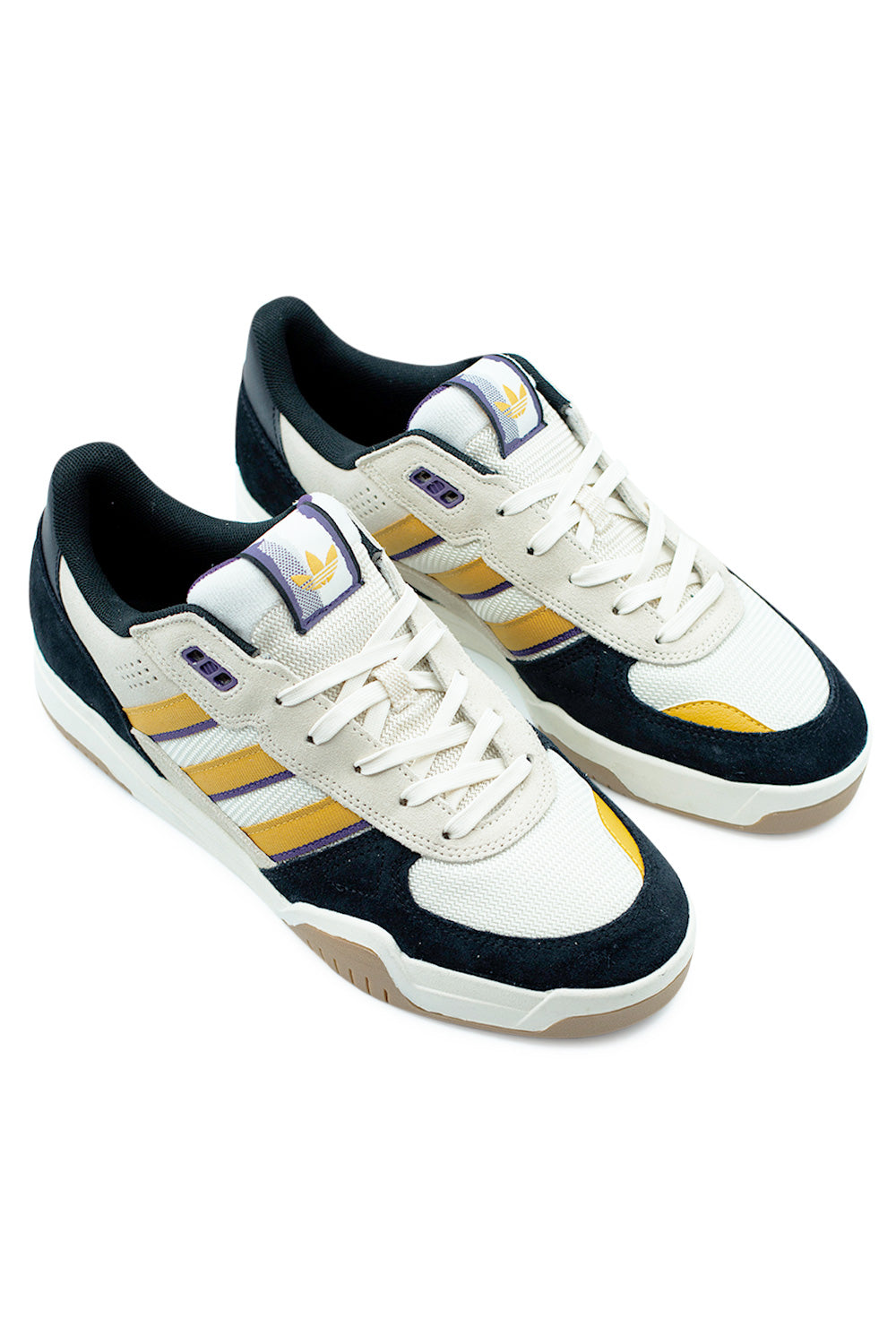 adidas Tekkira Cup sneakers in Cream White and Off White angled pair perspective highlighting retro court style, layered materials, gum outsole and clean minimalist aesthetic for lifestyle wear