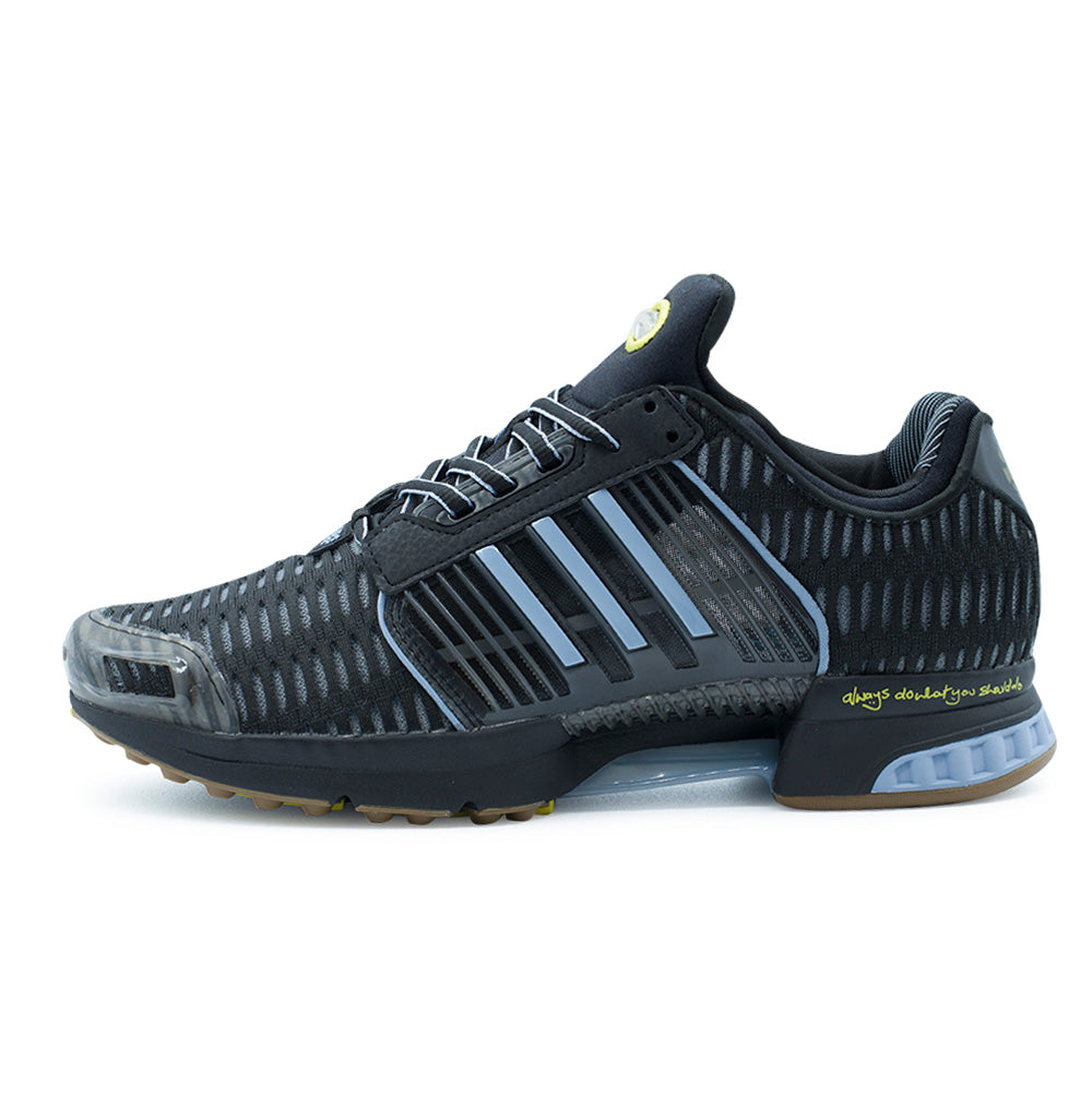 Lateral profile studio view of the adidas x ADWYSD Climacool 1 shoe in Core Black, Supplier Colour, and Cloud White, showcasing an early-2000s tech running silhouette with open-hole ventilated black knit mesh, molded pale blue Three Stripes cage, clear TPU toe cap, handwritten yellow "always do what you should do" heel text, and decoupled EVA midsole with icy blue accents.