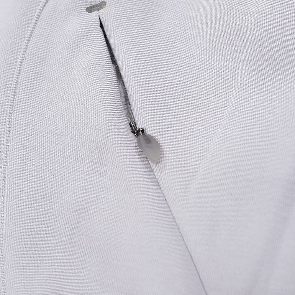 Macro close-up shot of the front waist pocket on the adidas x ADWYSD Full Zip Hoodie, highlighting the vertical hidden zipper seam, reinforced bartack end, and a translucent teardrop-shaped rubber zipper puller embossed with the adidas Trefoil logo.