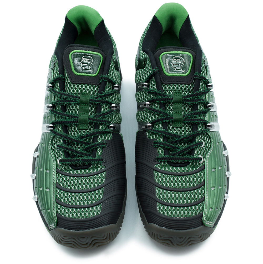 Top-down overhead studio shot of the adidas x Brain Dead Barricade V pair, detailing the asymmetrical forefoot construction with ribbed black rubber abrasion guards, two-tone woven laces, breathable forest green mesh, and translucent green Brain Dead head silhouette logo badges stitched onto both tongues.