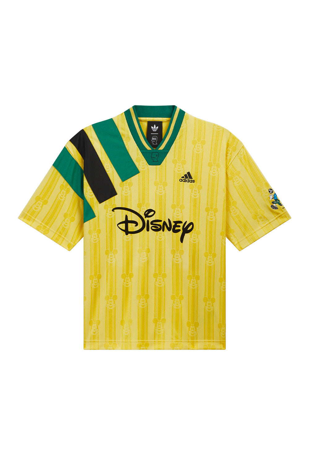 adidas x Brain Dead x Disney Football Jersey Bold Gold front view featuring all over woven Mickey Mouse pattern, oversized Disney flock print, embroidered adidas logo, Brain Dead collar logo, three sewn-on shoulder stripes and Goofy sleeve graphic from the limited World Cup capsule collection