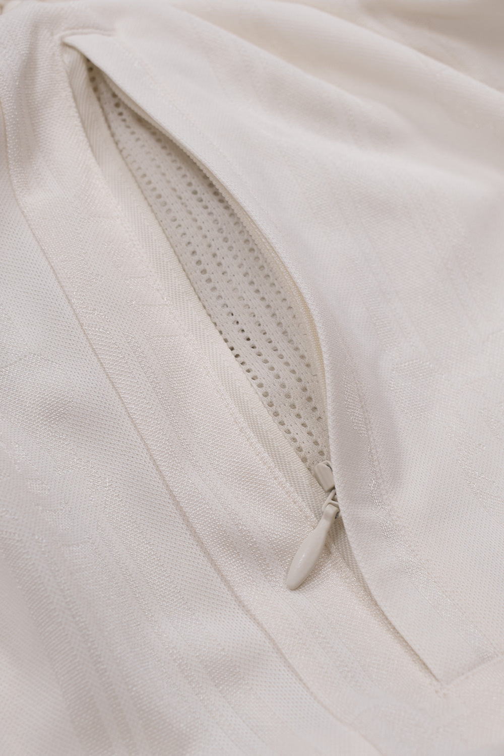 Close-up of the zippered side pocket on the adidas x Brain Dead x Disney Football Short Crystal White featuring breathable mesh lining, functional storage and premium construction