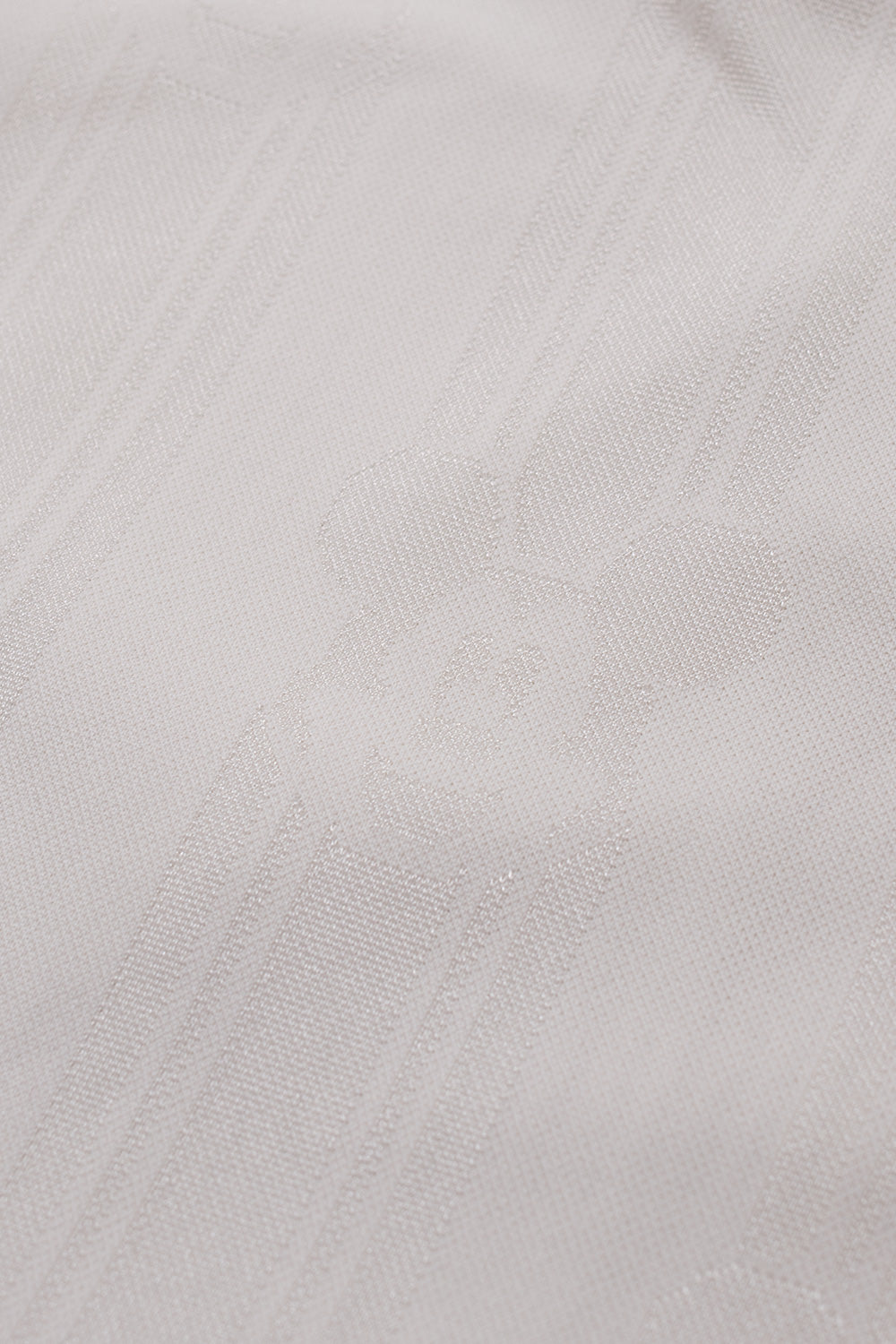 Close-up of the tonal all over Mickey Mouse jacquard fabric on the adidas x Brain Dead x Disney Football Short Crystal White showcasing premium polyester material and retro World Cup inspiration