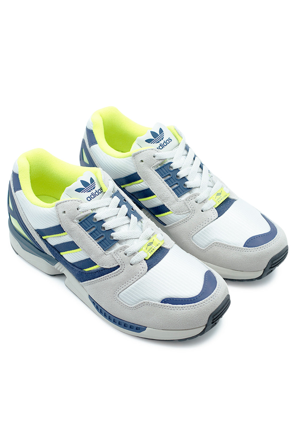 Adidas ZX 8000 Cloud White Dark Blue sneakers angled pair shot highlighting premium suede panels, ventilated mesh base and bold semi yellow details in a vintage tech runner aesthetic