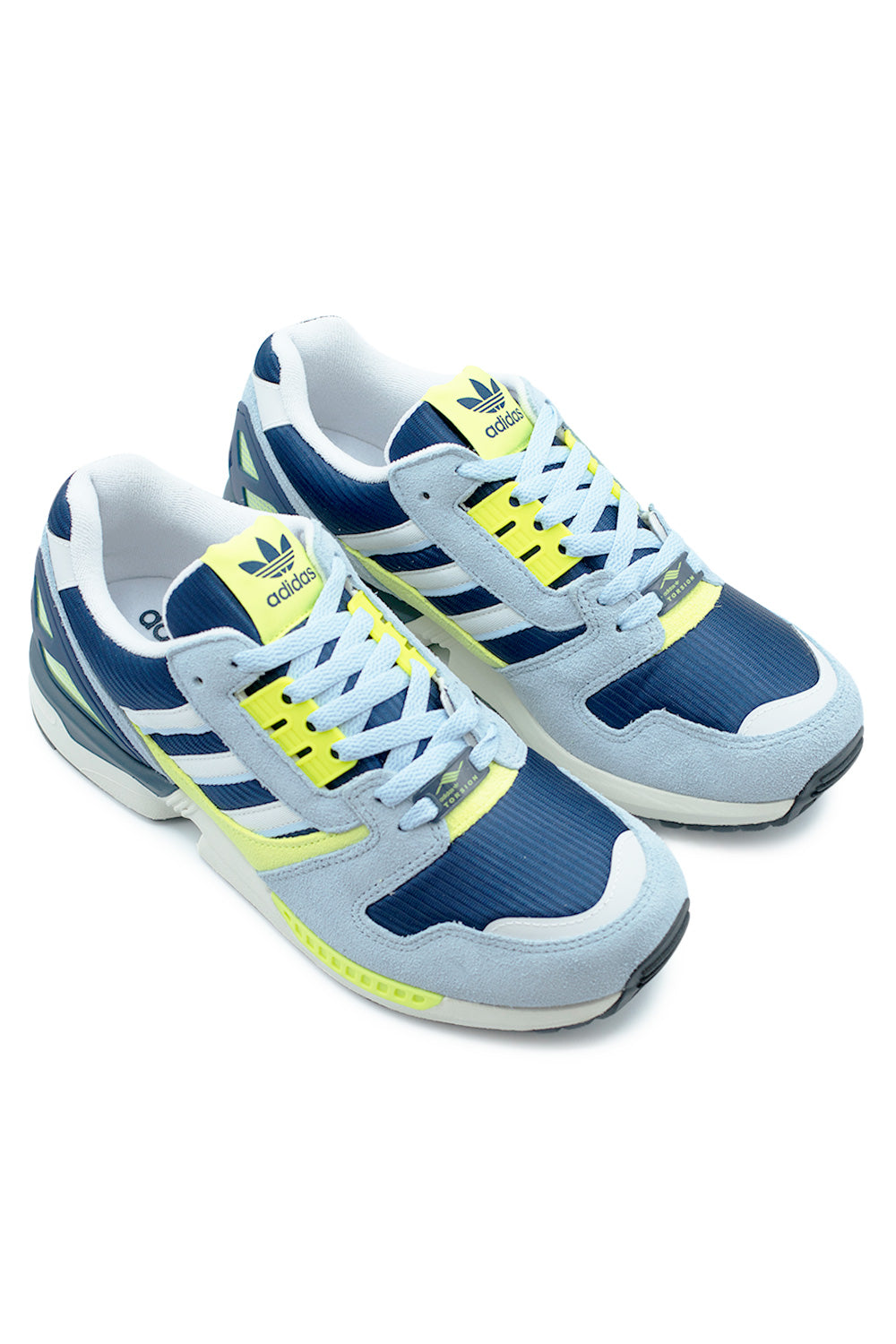 Adidas ZX 8000 Dark Blue sneaker pair angled perspective highlighting layered suede construction, Cloud White accents and bold Semi Yellow details inspired by terrace culture and retro sportswear