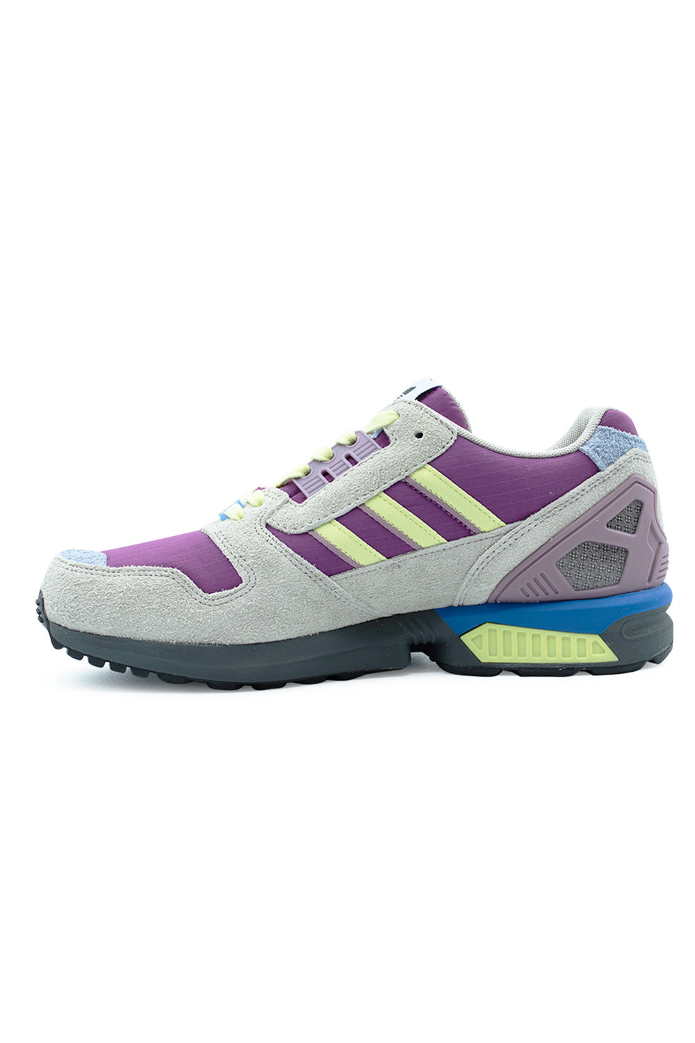 Medial arch profile view of the Adidas ZX 8000 sneaker, showing the inner hairy suede overlays, Lucky Pink ripstop quarter underlay, pale yellow leather Three Stripes, sculpted EVA midsole with textured soft yellow TPU insert, and blue heel crash pad.