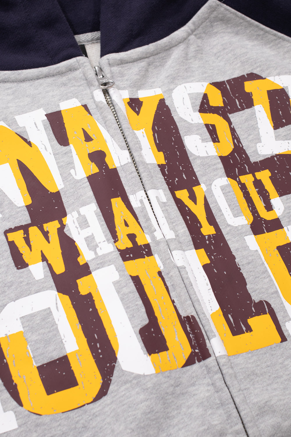 Close-up shot of the front chest graphic and silver YKK zipper closure on the heather grey Always hoodie, highlighting the distressed vintage text print reading "Always Do What You Should Do" with layered white block lettering and yellow outlined shadows.