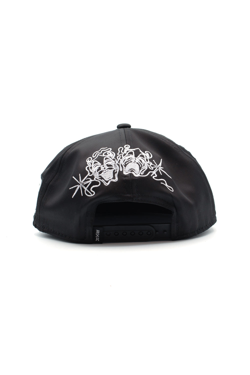 Rear view of the black Born X Raised Boxing Hat, displaying white embroidered drama mask graphics above the adjustable plastic snapback closure.