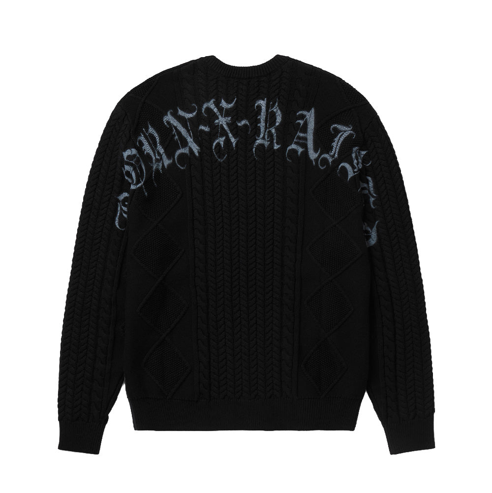 Back flat lay studio view of the black Born X Raised Two Pair Cable Knit Sweater, highlighting the continuous textured diamond and braided cable-knit stitches across the back panel, complemented by an oversized arched "BORN-X-RAISED" logo printed in distressed grey Old English Gothic calligraphy across the upper shoulders.