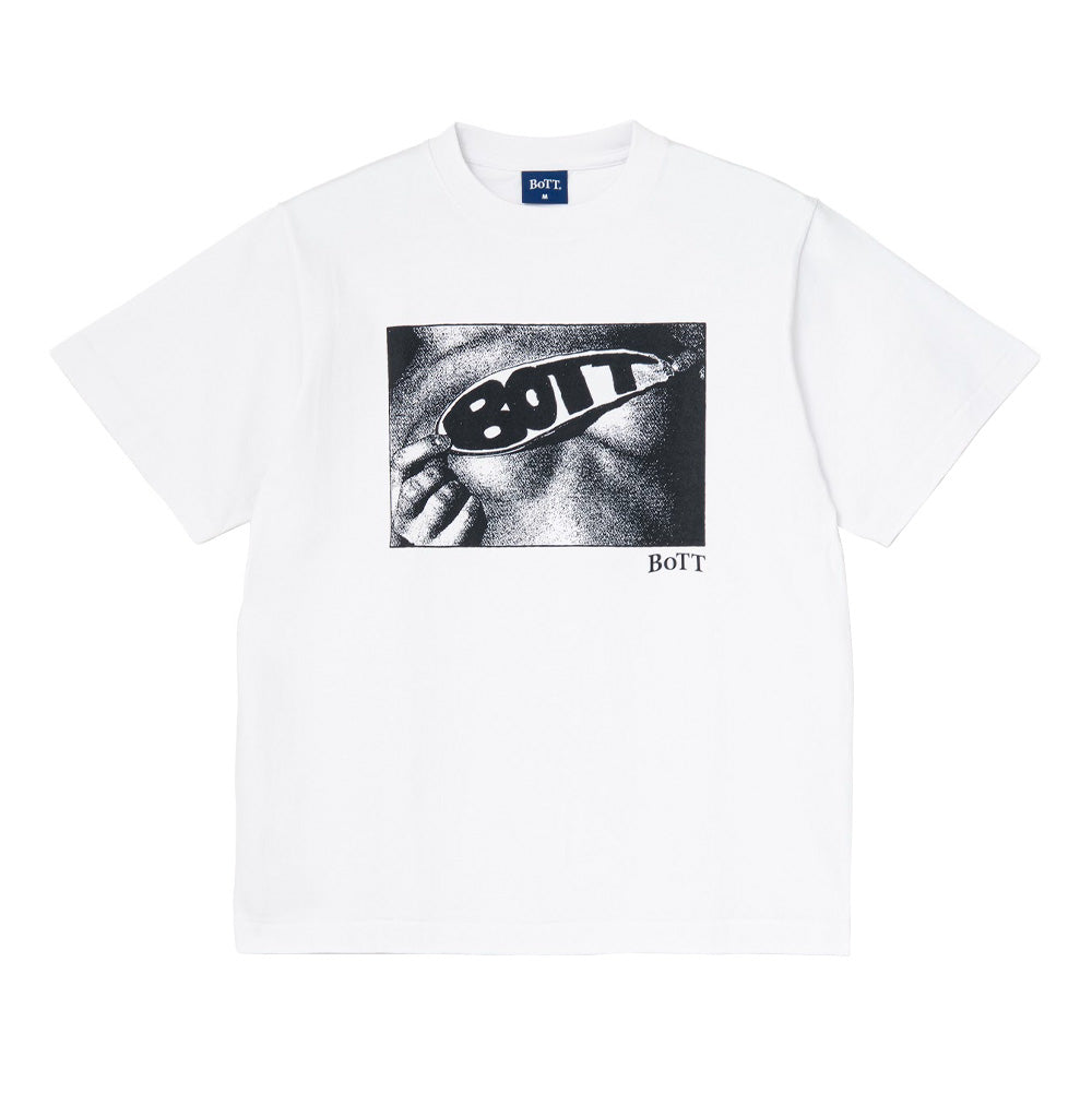 Front flat lay studio view of the BoTT Lust T-Shirt in solid white, showcasing a relaxed boxy skateboarder fit in heavy cotton jersey, a ribbed crew neckline with a blue woven BoTT neck tag, and a centered rectangular black-and-white graphic print depicting a close-up face wearing retro oval sunglasses branded with bold "BOTT" typography.