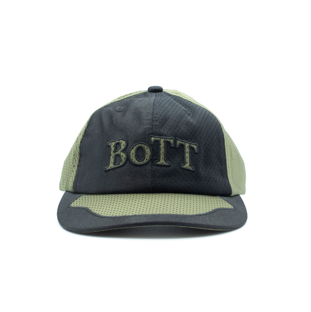 Front perspective studio view of the BoTT Mesh Paneled Cap in Olive and Black, showcasing a technical outdoor skate cap tailored with breathable eyelet mesh panels in olive green and dark charcoal, a curved visor with two-tone panelling, and olive green embroidered serif "BOTT" logo lettering centered across the front crown.