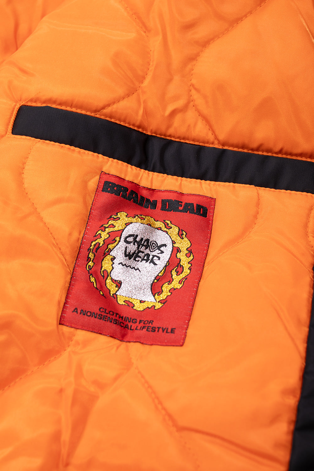 Side view of Brain Dead Embroidered 3D Flight Jacket Black, water-repellent outerwear with logo embroidery, inside pocket, and ribbed cuffs.