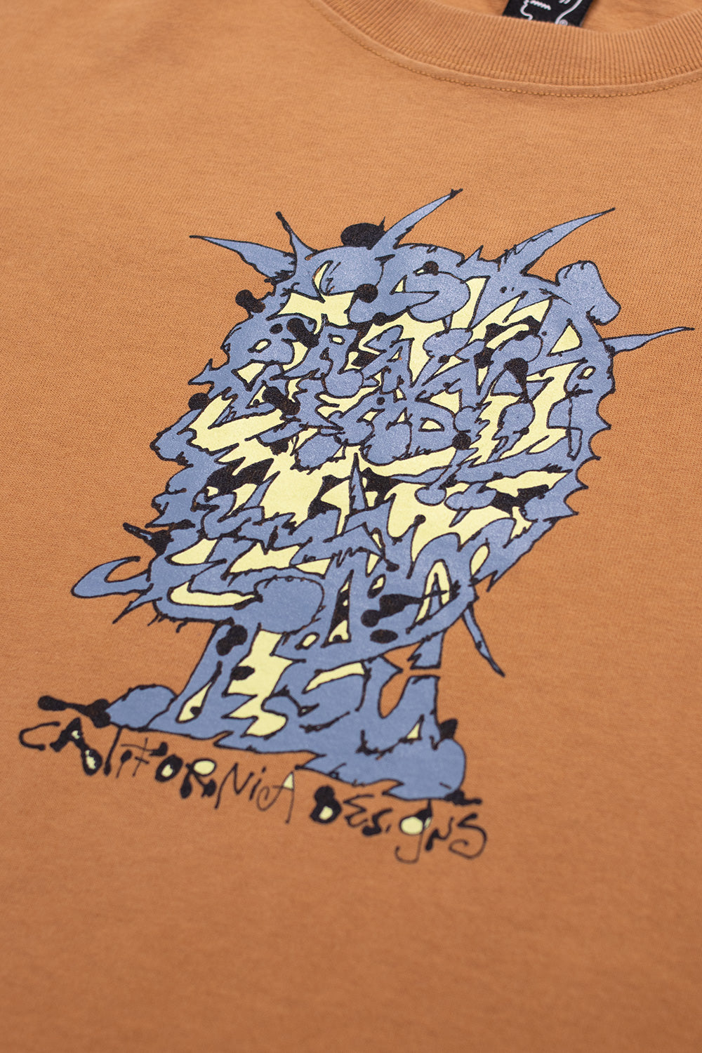 Brain Dead Scrambled Head T-Shirt Cumin - BONKERS