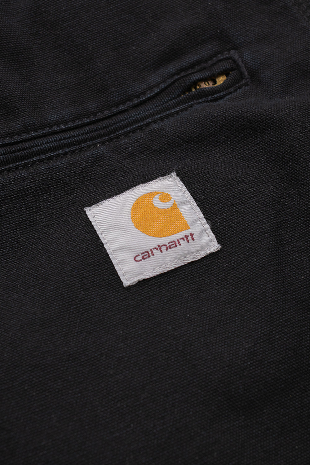 "Nahaufnahme der Carhartt WIP OG Detroit Jacket in Black/Black Aged Canvas – robuste Verarbeitung und zeitlose Details, inspiriert von traditioneller Workwear"