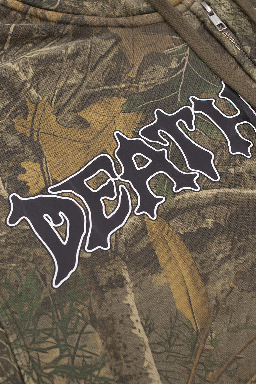 Close-up detail of the graphic print on the tree camo fabric, showing the word Death in a stylized black metal font with a white outline.