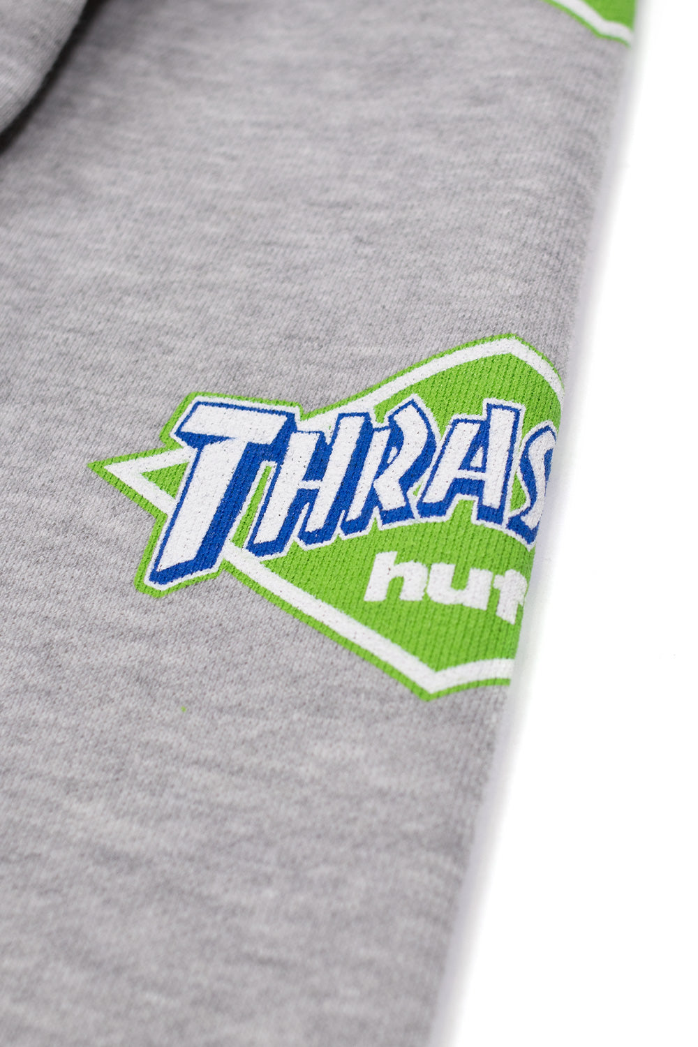 Unisex HUF x Thrasher Hoodie Heather Grey, premium cotton-blend pullover with iconic skate collaboration graphics and relaxed fit.