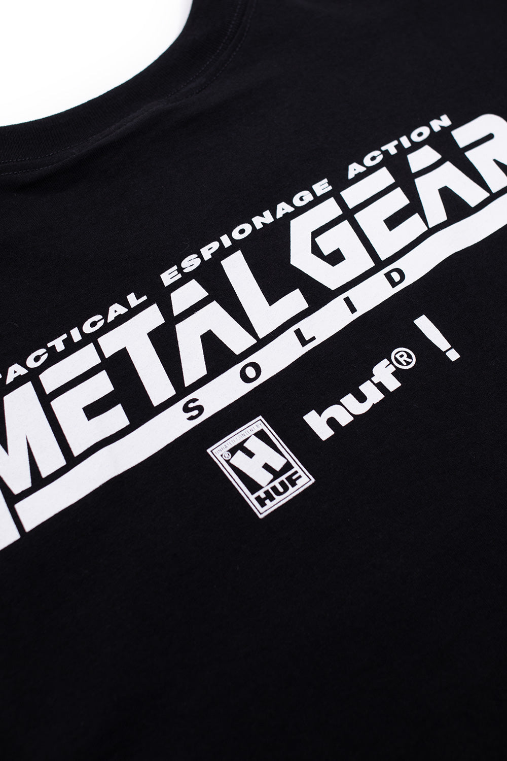 Close-up of HUF Metal Gear Solid MGS1 T-Shirt black featuring detailed Solid Snake illustration, tactical espionage action graphic, premium 250 gsm cotton construction