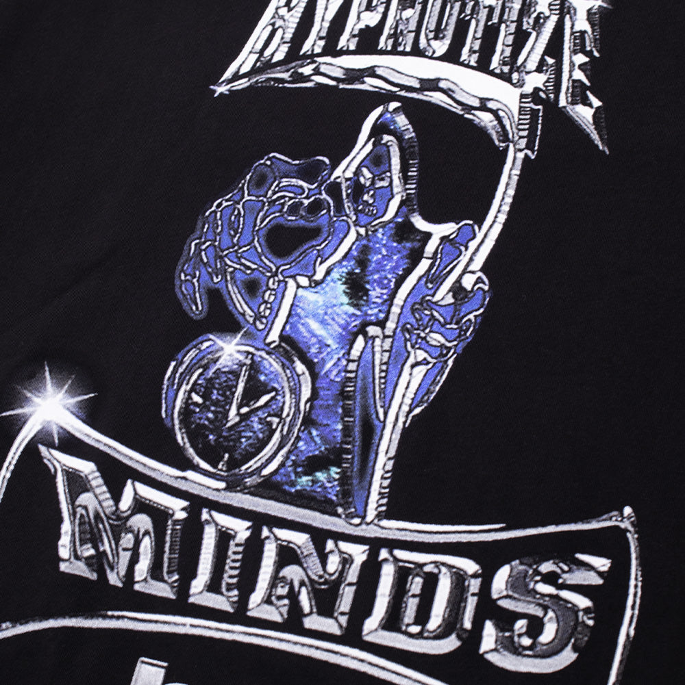 Macro close-up shot of the front chest graphic on the Huf X Three 6 Mafia Sizzurp T-Shirt, highlighting the intricate airbrushed details of the skeletal grim reaper enveloped in purple and blue hues, the sparkling metallic hourglass timepiece, and chrome bevel lettering on black cotton jersey.