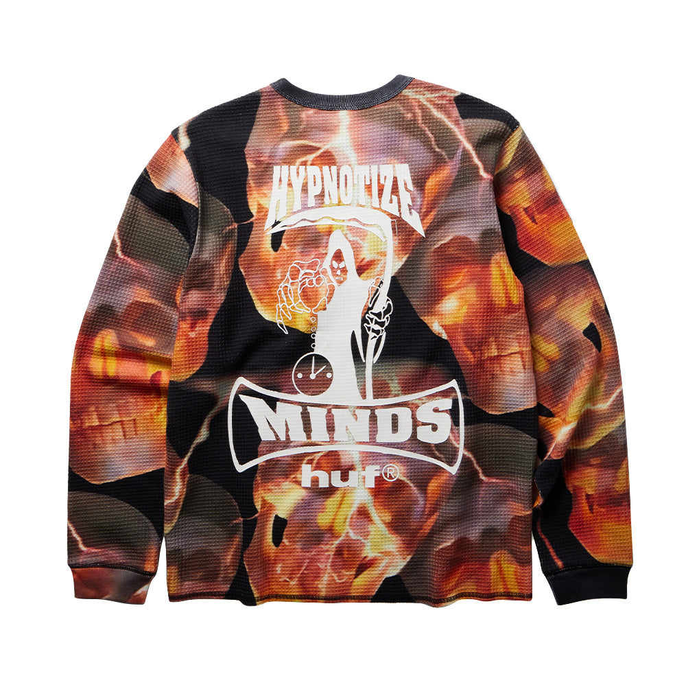 Back flat lay view of the Huf X Three 6 Mafia Torched Longsleeve Thermal, displaying the seamless burning skull pattern across the waffle thermal knit, centered with a large white graphic of the Hypnotize Minds grim reaper clutching an hourglass and scythe, framed by arched "HYPNOTIZE MINDS" banners and the "huf®" logo.