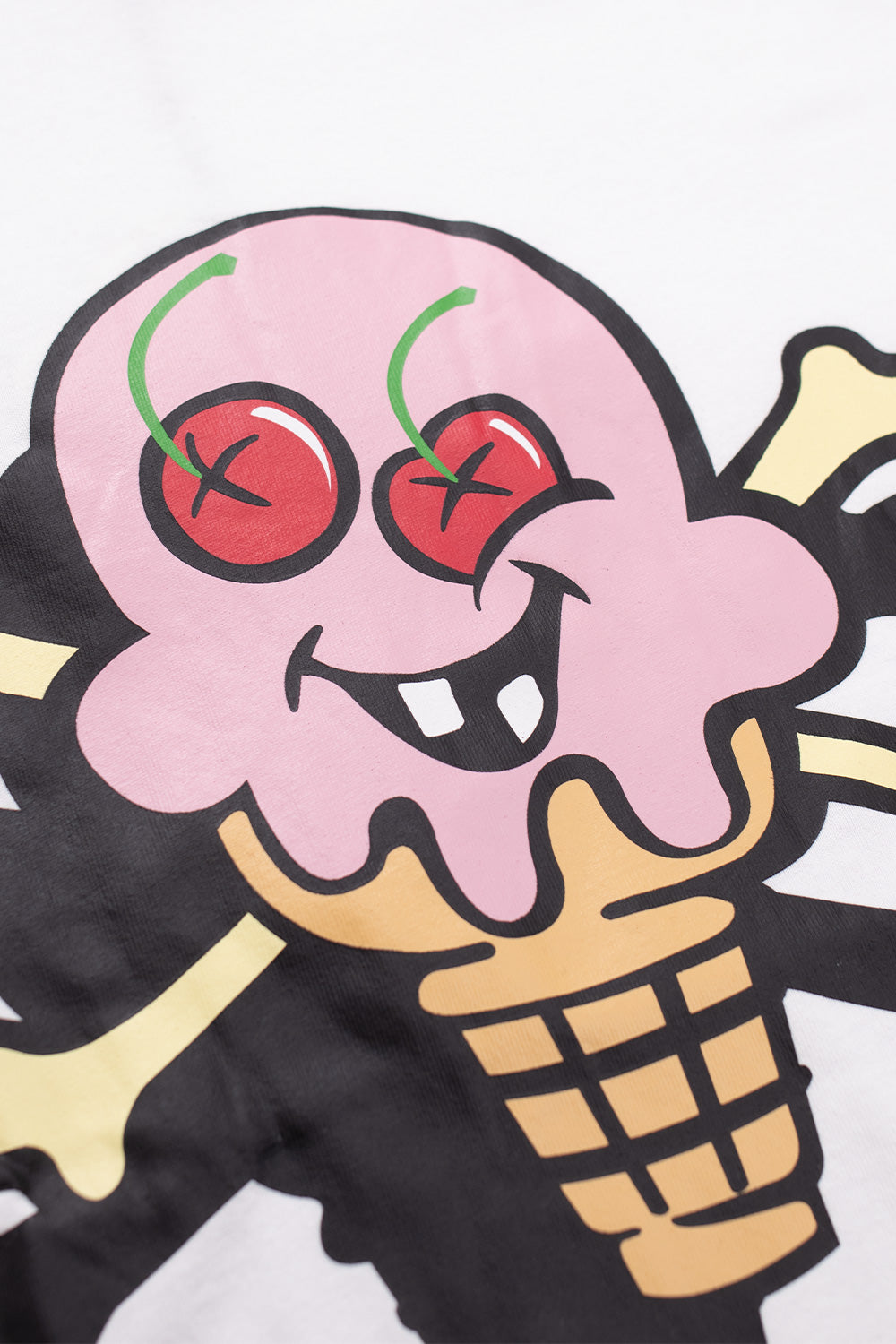Close-up of IceCream Cones & Bones graphic on white tee showing vibrant cherries and melting cone design, highlighting premium print quality and skateboarding-inspired IceCream streetwear aesthetics.