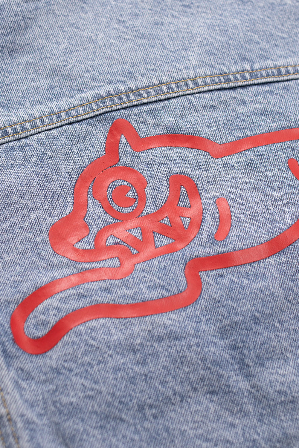 Vintage-inspired denim trucker jacket by Ice Cream with a red running dog design