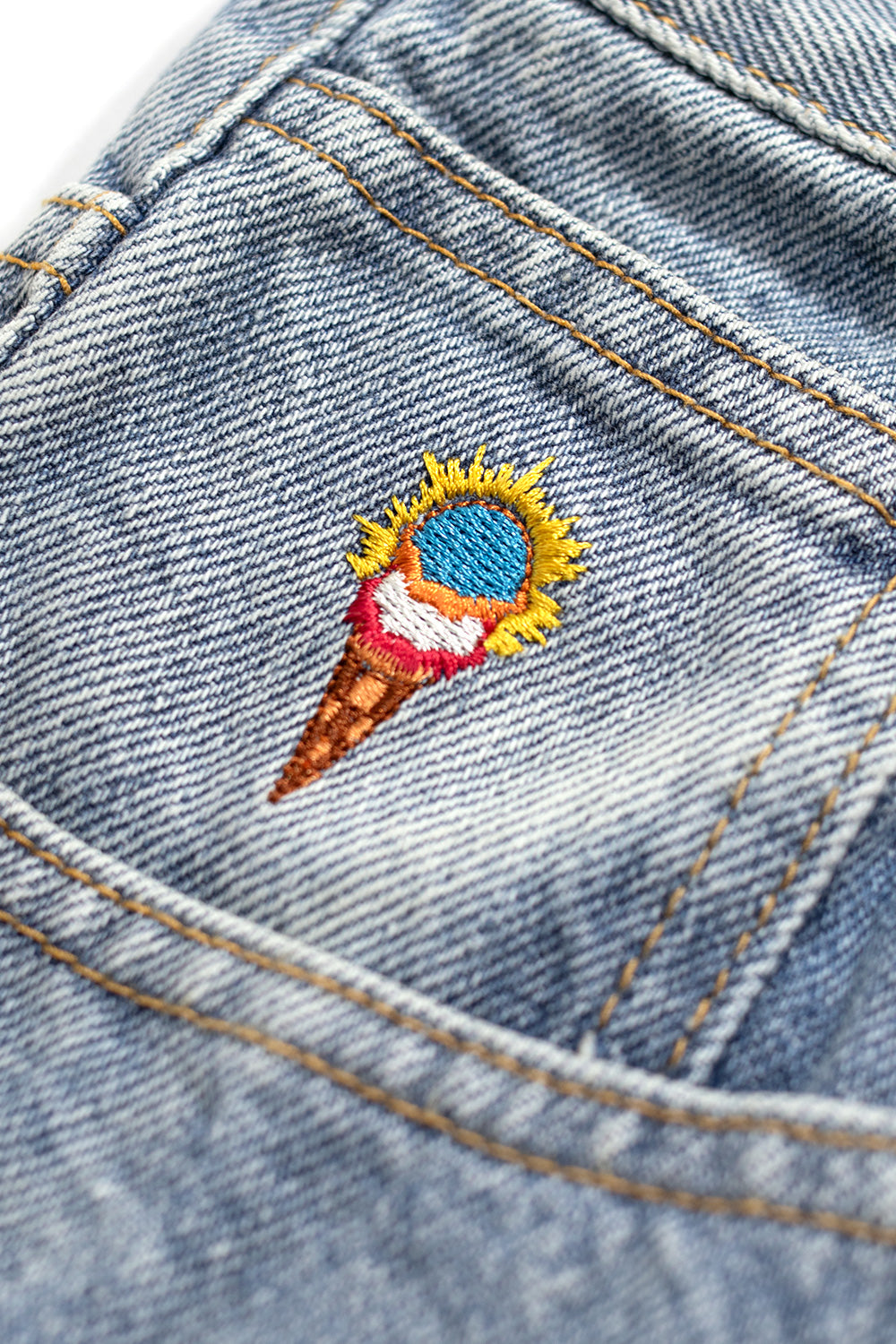 Casual Ice Cream light blue denim pants featuring red Running Dog graphic on the leg