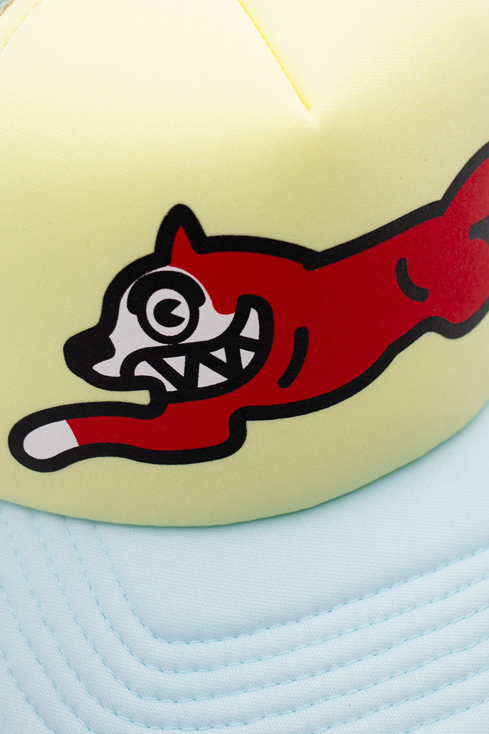 Ice Cream Running Dog ecru trucker cap with a bold logo, perfect for streetwear fashion