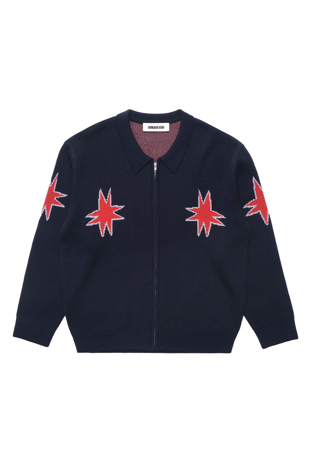 Front view of the Metalwood Studio Kiki Zip Knit LS Polo in navy, featuring heavy-weight wool blend construction, all-around red star pattern graphics, and a two-way YKK zipper.