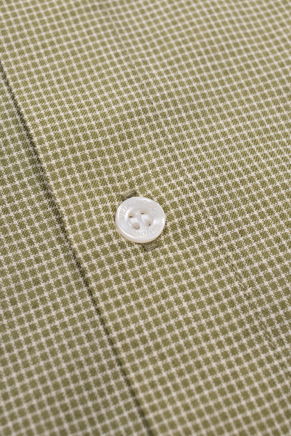 Metalwood Studio Micro Grind Shirt close-up featuring custom logo buttons, concealed front placket and premium oversized shirt construction