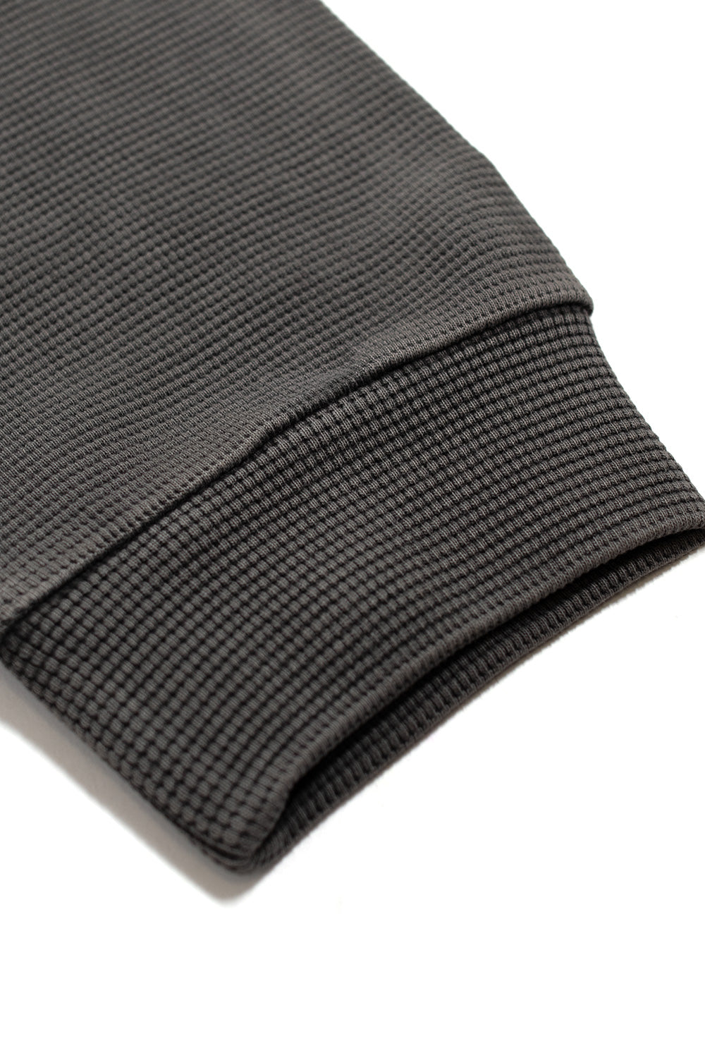 Detailed view of the Metalwood Studio Tar thermal shirt sleeve cuff highlighting the heavy waffle knit construction and premium 100% cotton texture.
