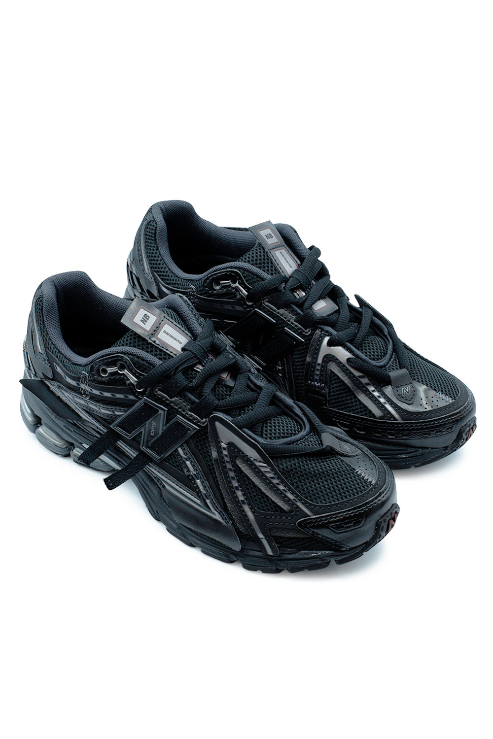 Angled pair shot of the New Balance 1906A lifestyle sneaker displaying layered synthetic panels, technical mesh upper, signature N-Lock support system, futuristic Refined Future aesthetic and premium Black / Dark Silver Metallic finish.
