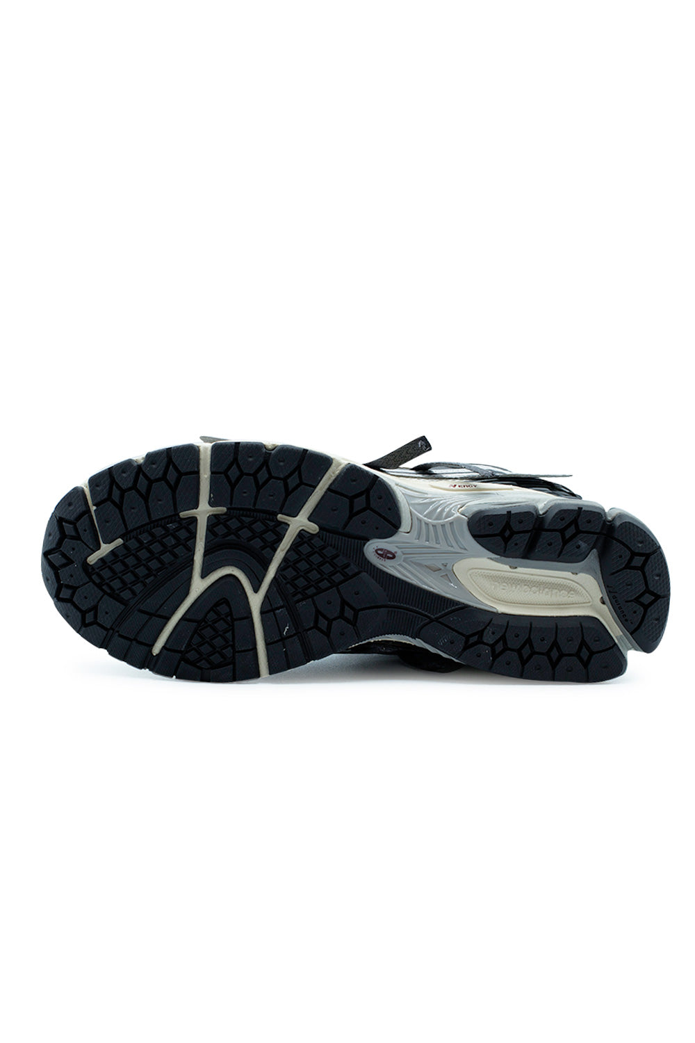Outsole detail of the New Balance 1906A Silver Metallic / Castlerock / Gold Metallic revealing the durable rubber traction pattern, Stability Web midfoot shank, N-ergy cushioning system and performance outsole built for grip, stability and daily wear.