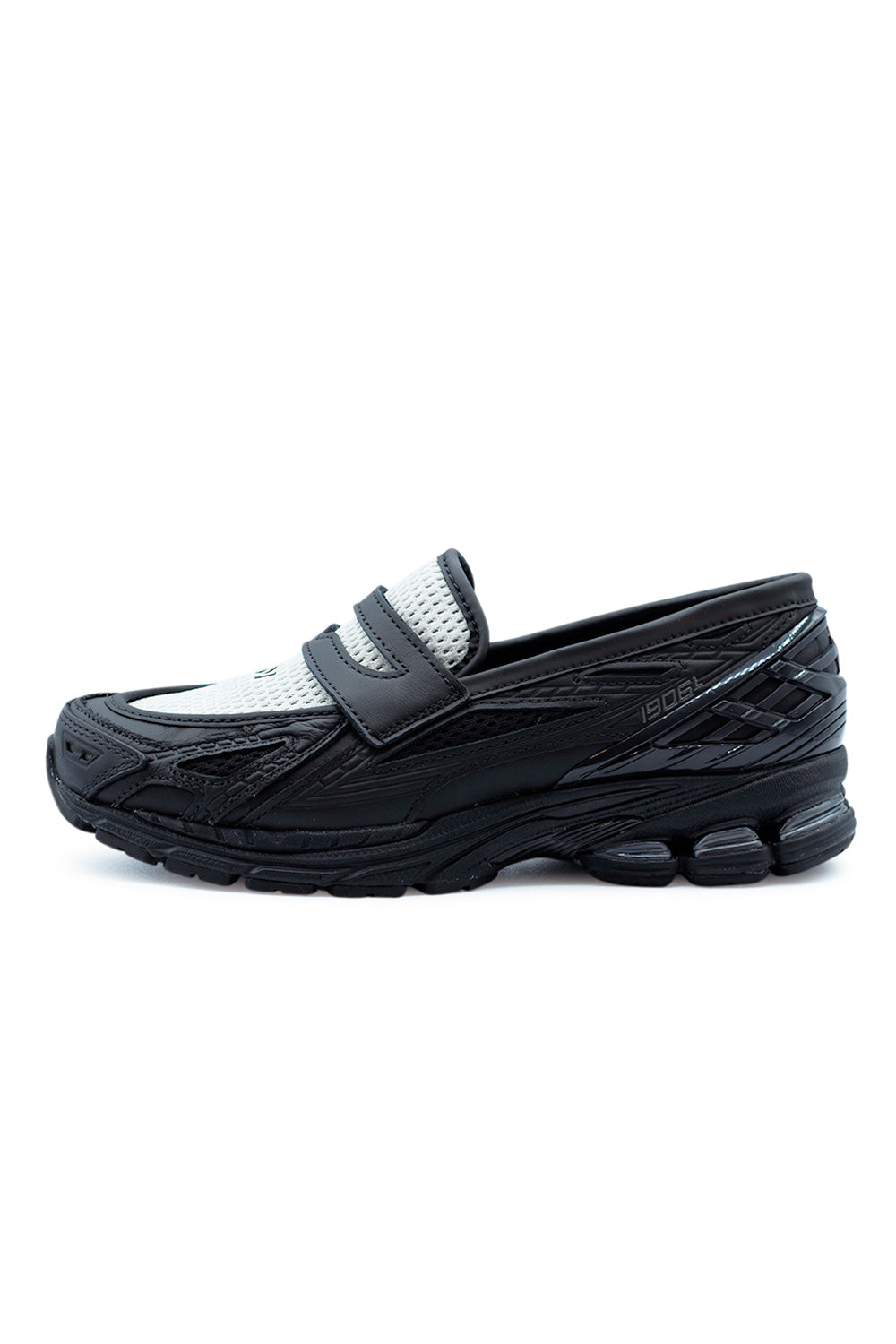 New Balance 1906L loafer sneaker in Black and Angora featuring a hybrid penny loafer design with performance running sole, combining modern formal footwear style with advanced sneaker cushioning.