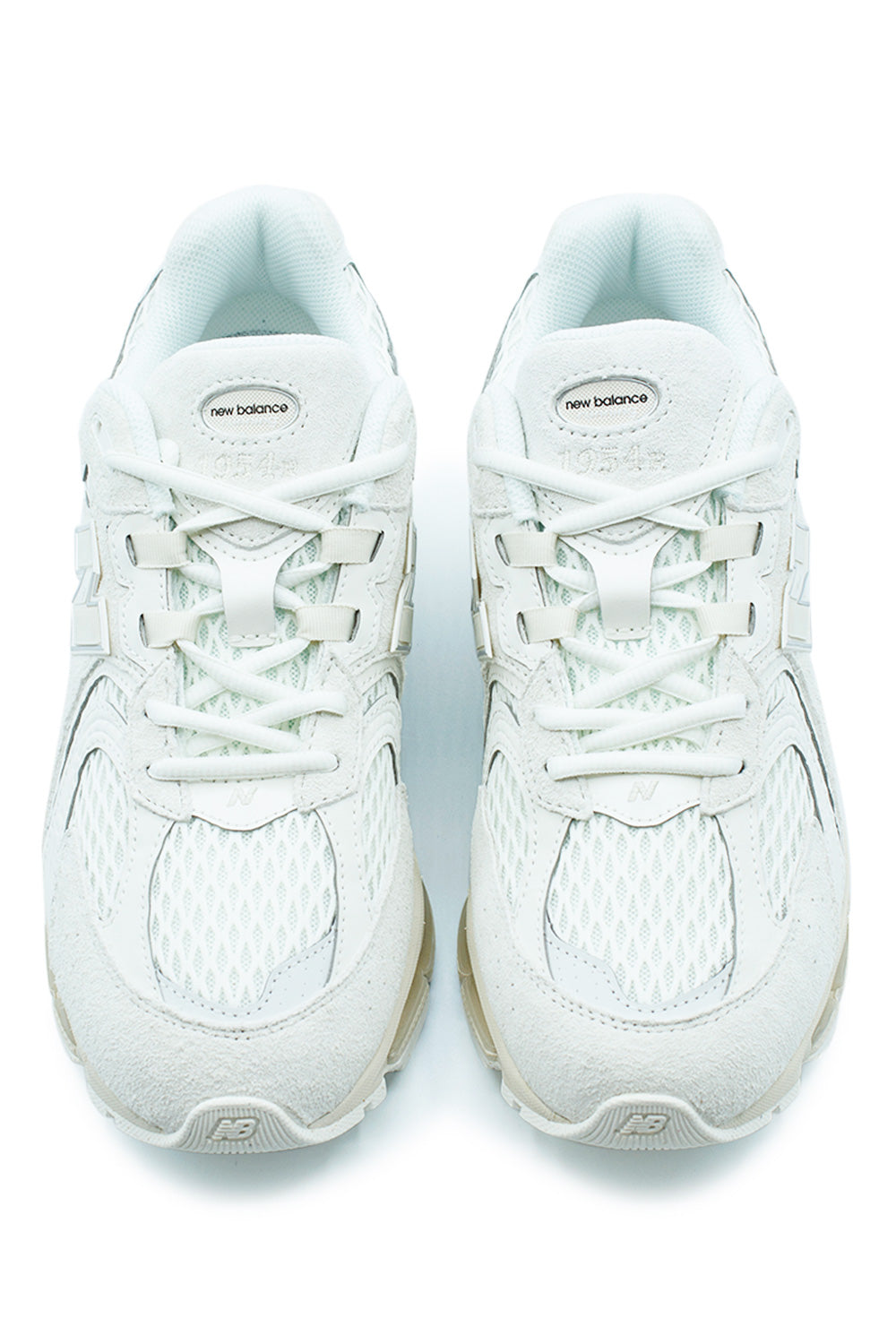 Front view of the New Balance 1954R U19541R3 showcasing layered suede panels, engineered mesh toe box, tonal Sea Salt and Linen color palette, secure lace system and contemporary retro running sneaker construction.