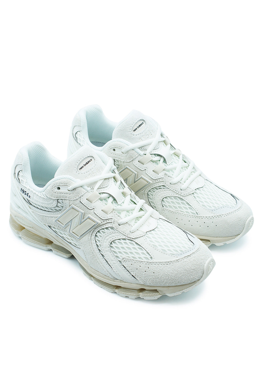 Angled pair shot of the New Balance 1954R in Sea Salt / Linen featuring breathable mesh, luxurious pig suede overlays, oversized ABZORB sole unit, iconic New Balance branding and refined early-2000s performance running aesthetics.