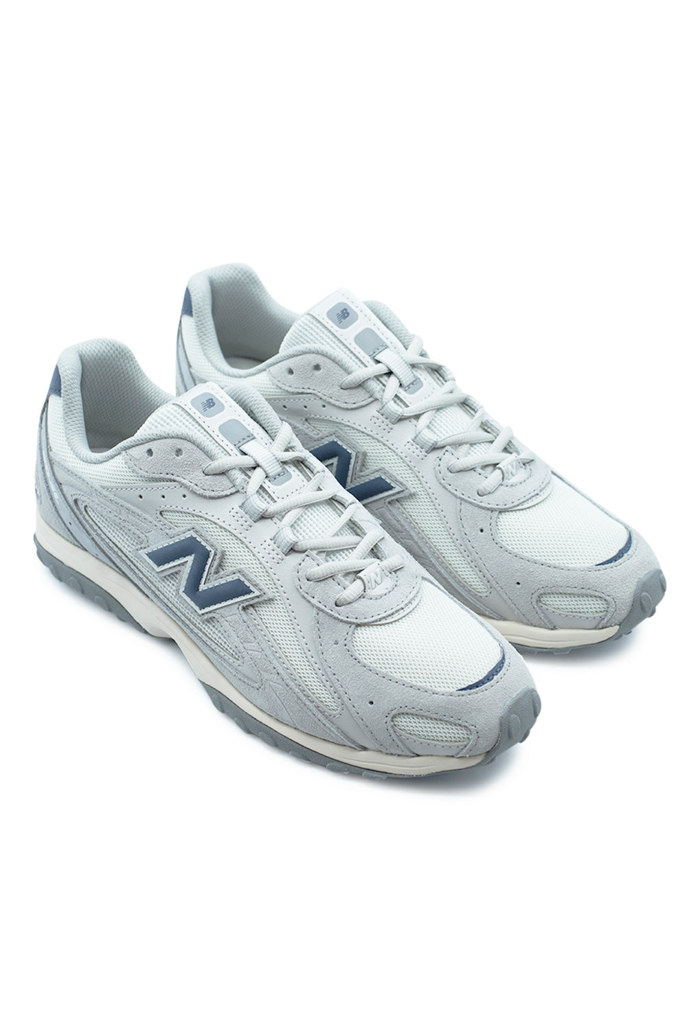 angled pair of New Balance 204L Raincloud Ash Wood sneakers showcasing neutral grey tones, vintage running inspired shape and modern casual streetwear appeal