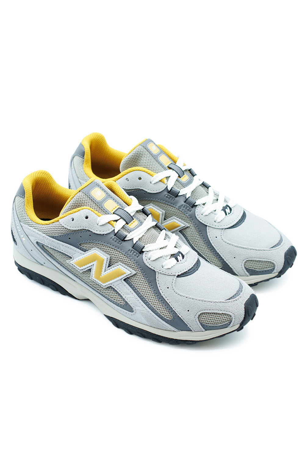 Side view of New Balance 204L Shoe Raincloud Baroque Gold, vintage-inspired running shoe with stacked suede N logo and 2000s-style outsole.