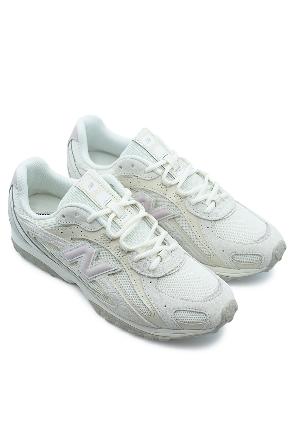pair of New Balance 204L Sea Salt Stone Pink sneakers angled view showing vintage inspired running silhouette, pastel accents and modern streetwear styling