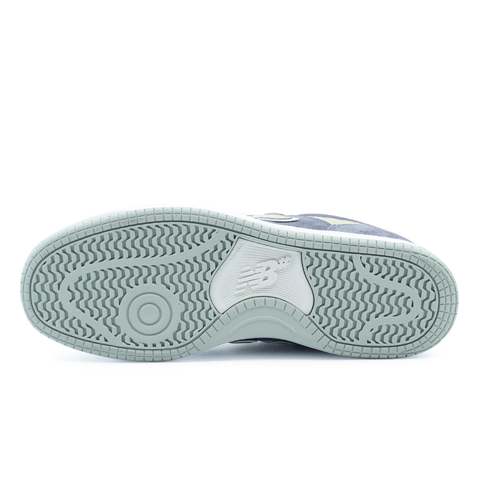 Full bottom studio view of the New Balance Numeric 480 outsole, detailing the light sage grey rubber cupsole equipped with multidirectional wavy herringbone traction grooves, a circular forefoot pivot point for board feel, and a debossed NB# logo within the central midfoot arch bridge.