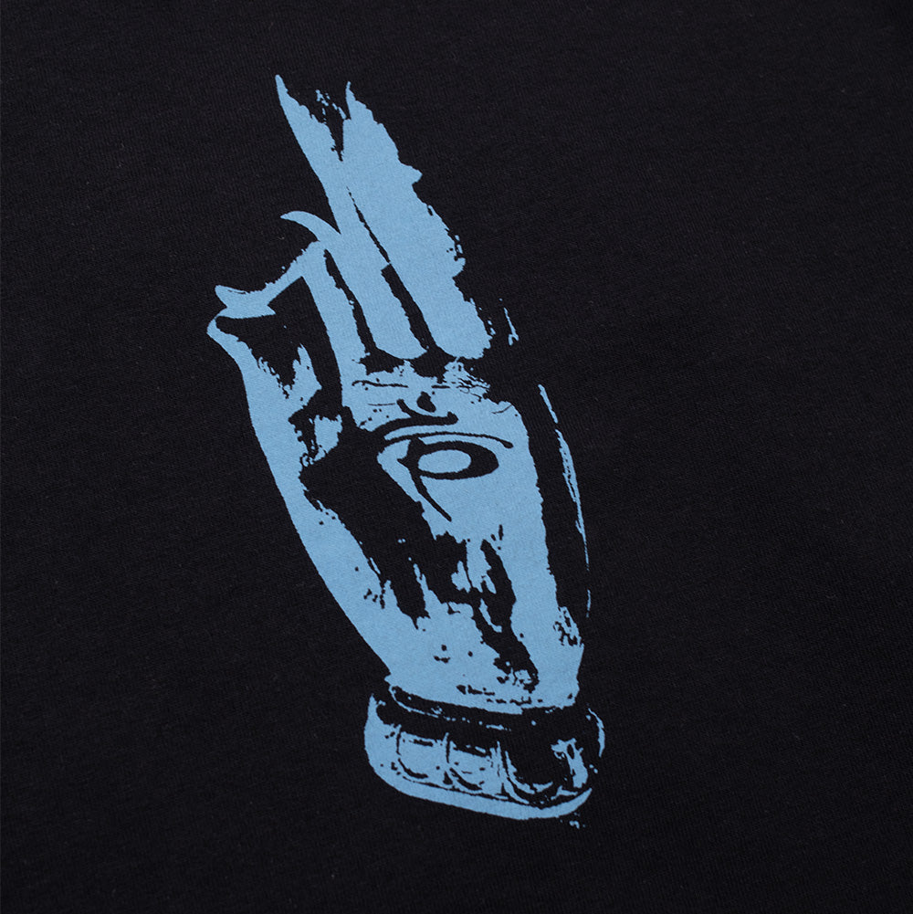 Macro perspective of the front chest graphic on the Aries No Problemo Holy Mountain T-Shirt, showing the single-color blue screen print of an illustrated esoteric hand held in a mudra blessing gesture with an evil eye symbol on the palm.